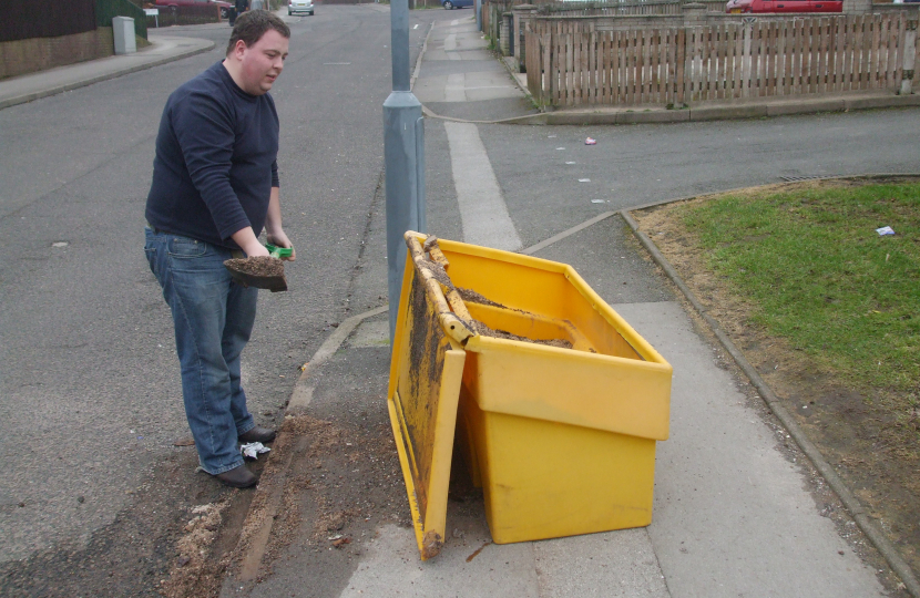 Gary Sambrook clearing up the mess from an overturned grit bin.