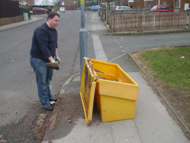 Gary Sambrook clearing up the mess from an overturned grit bin.