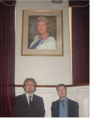 Robert and Gareth by the portrait of the Queen