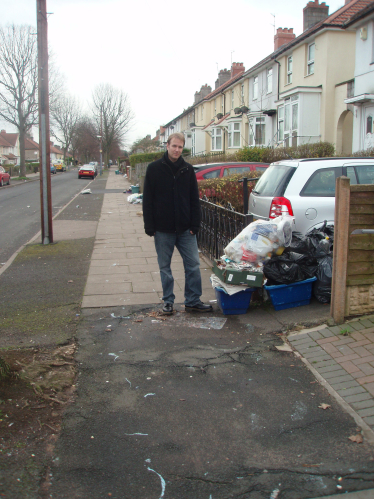 Cllr Matt Bennett next to uncollected rubbish bags on Brookvale Park Road